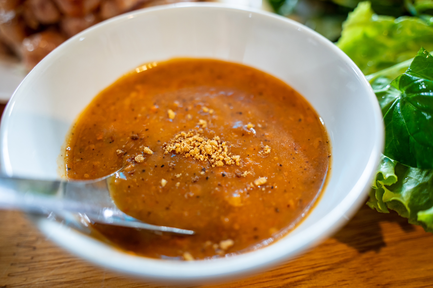 Peanut sauce eat with grilled pork wrap and roll in vegetable herbs. Vietnamese food