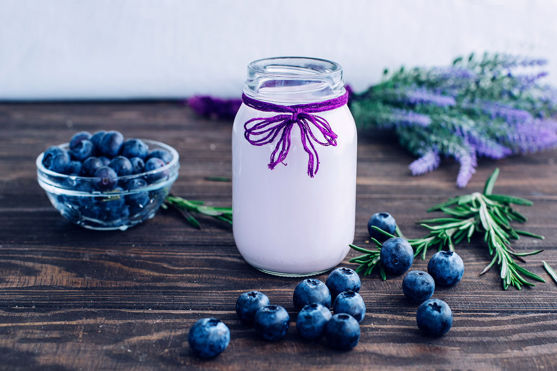 Smoothies with blueberries on a wooden table